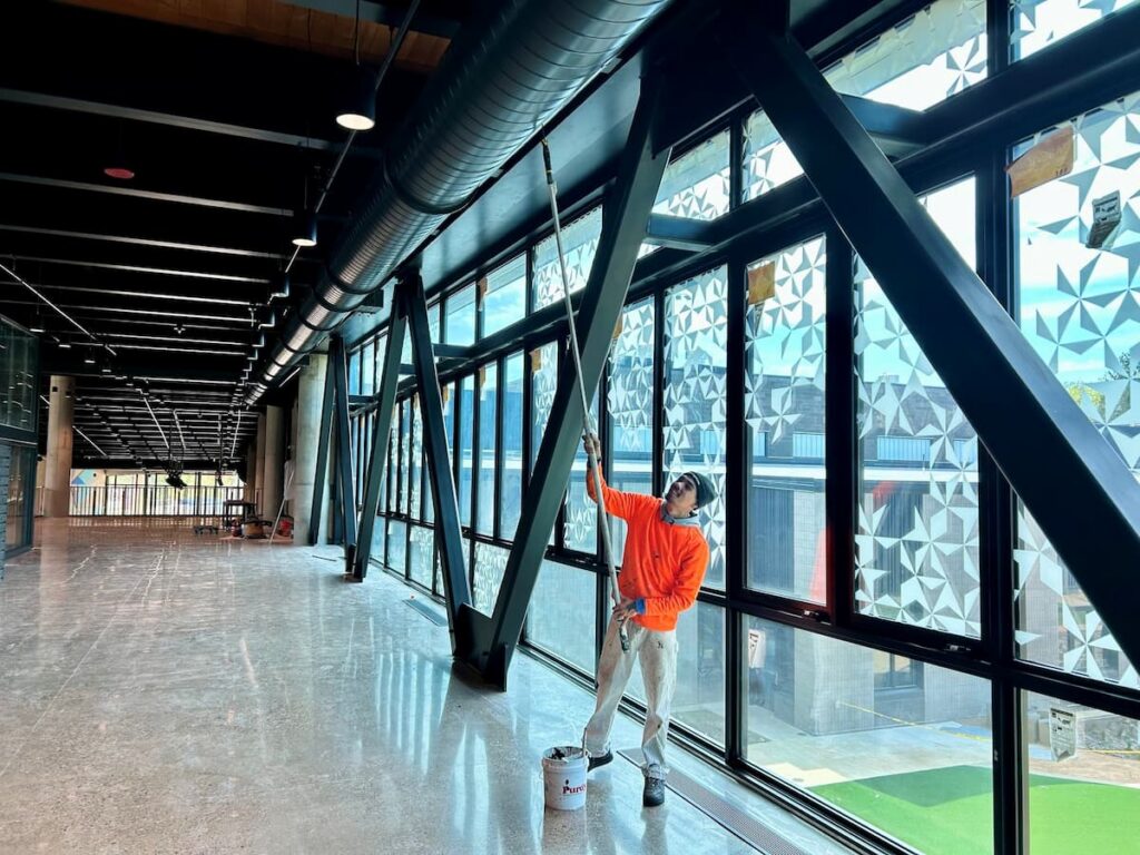 Middle School interior painting ceiling beams
